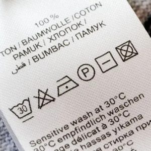 Washing care label with garment care instructions and symbols